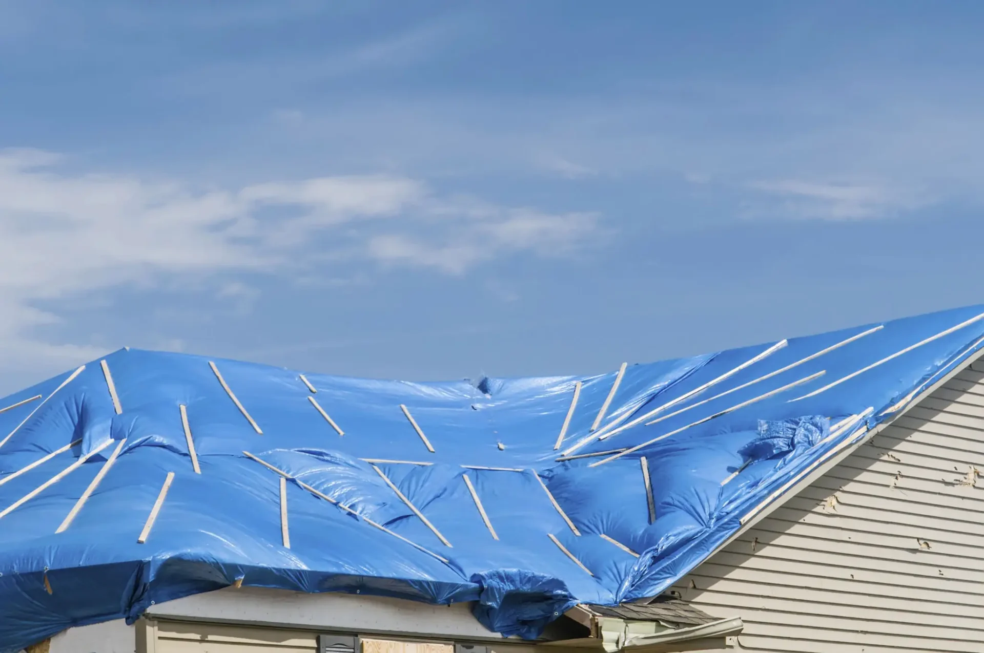 Temporary roof cover with tarp