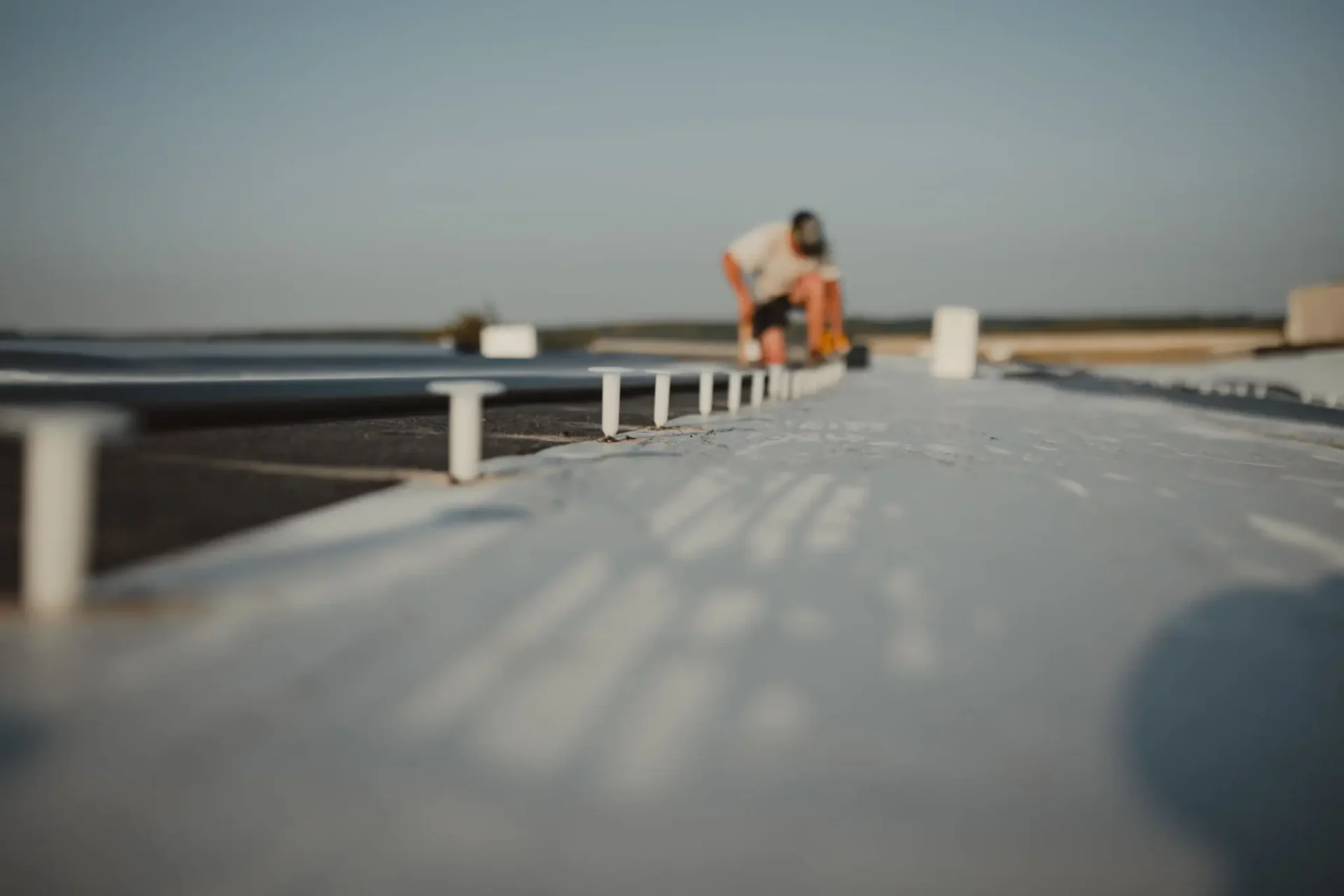 Roofer working on flat rooftop