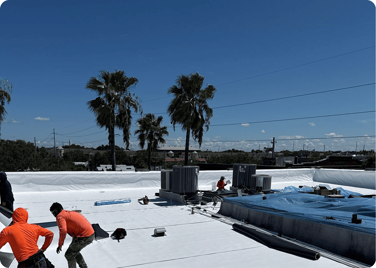 Crew working on white rooftop surface