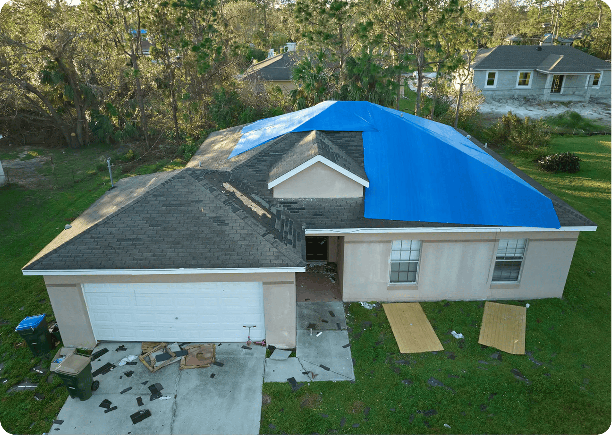 House roof with temporary blue covering