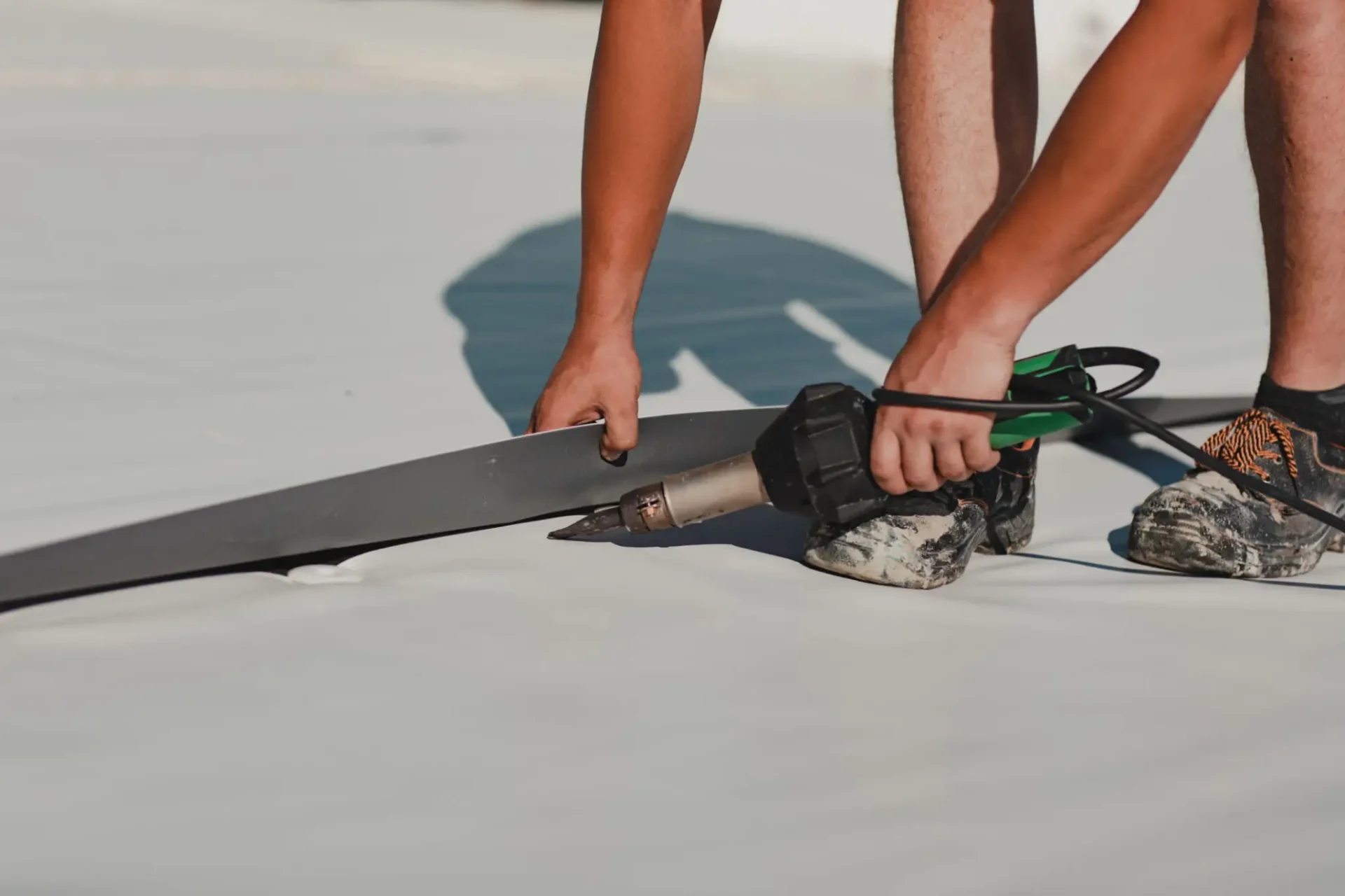Installing roofing membrane with heat gun