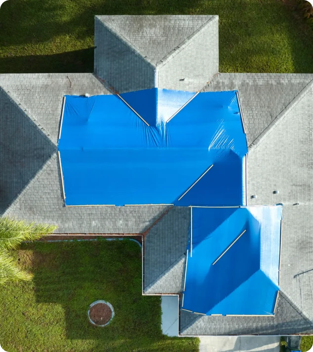 Blue tarp covering house roof
