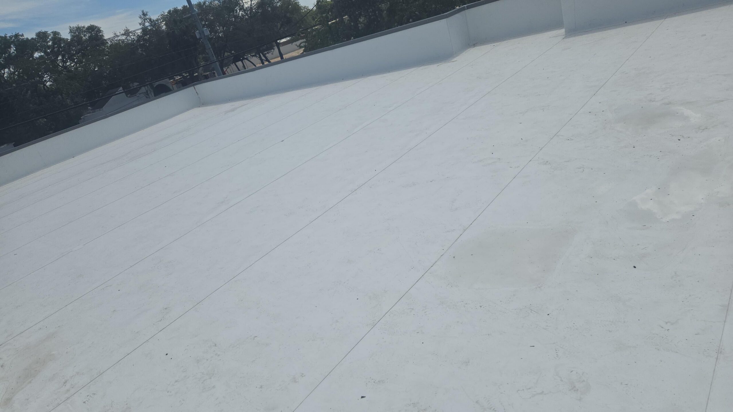 White rooftop with clear sky view.