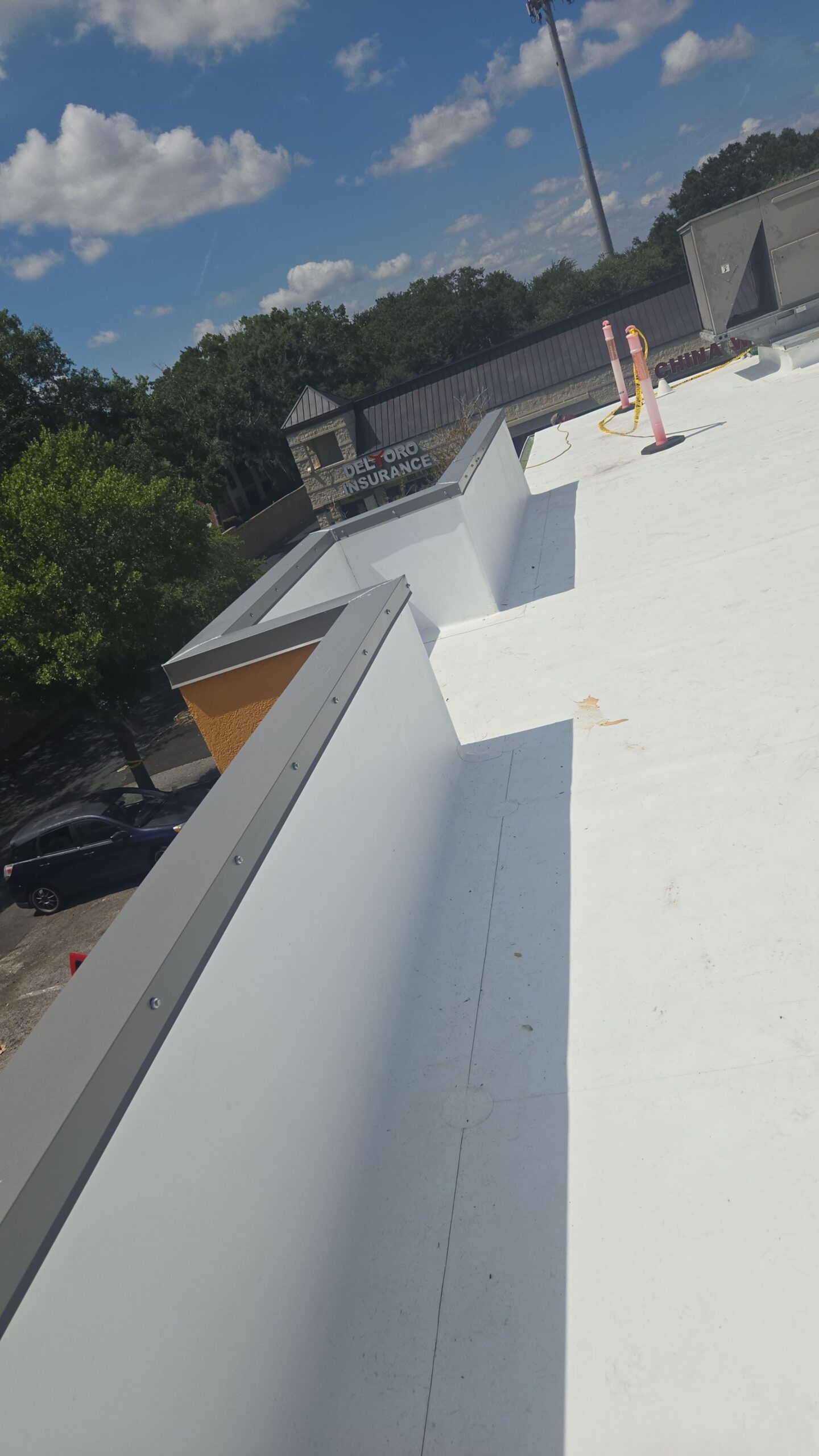 Rooftop with white surface under blue sky