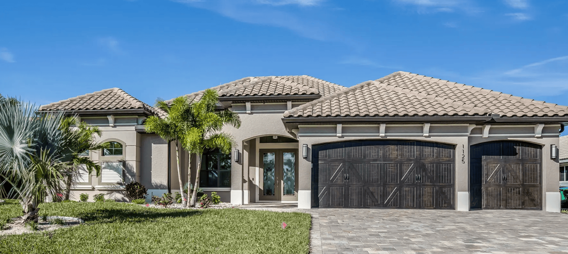 Elegant home exterior with palm trees